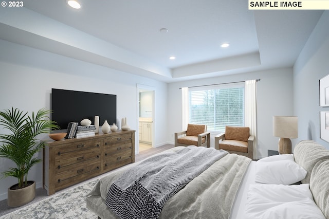 bedroom with recessed lighting, ensuite bathroom, a raised ceiling, and baseboards