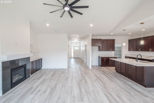774 Riley Dr, Silverton, OR 97381 - kitchen with ceiling fan, a fireplace, light countertops, dark brown cabinets, and recessed lighting