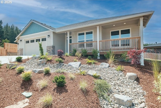 774 Riley Dr, Silverton, OR 97381 - view of front of property with covered porch, a garage, stone siding, and driveway