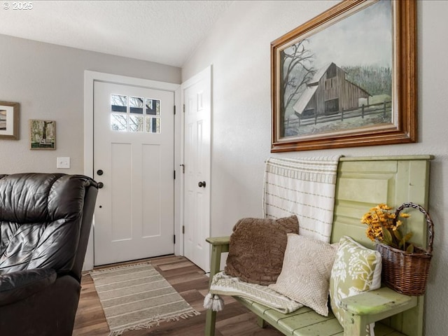 interior space featuring a textured ceiling and wood finished floors