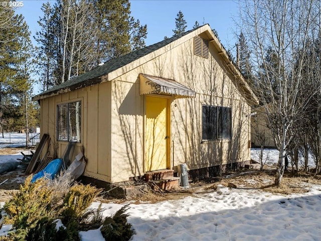 snow covered structure featuring entry steps