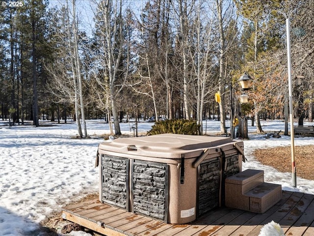 snow covered deck featuring a hot tub