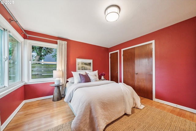 bedroom with wood finished floors and baseboards