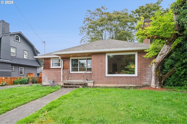 bungalow-style house with brick siding, a chimney, and a shingled roof