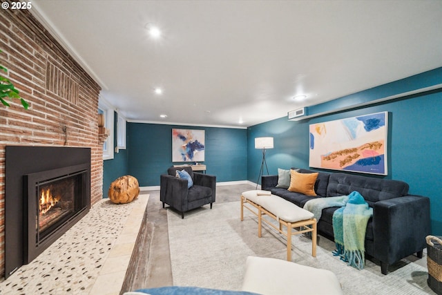 living area featuring a brick fireplace, recessed lighting, and crown molding