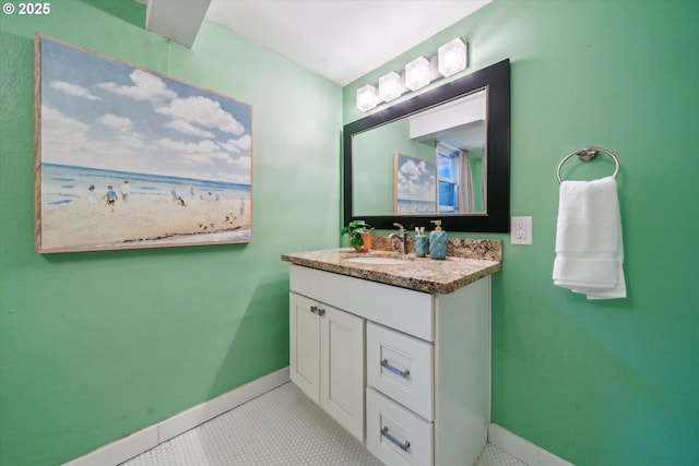 bathroom featuring baseboards, vanity, and tile patterned flooring