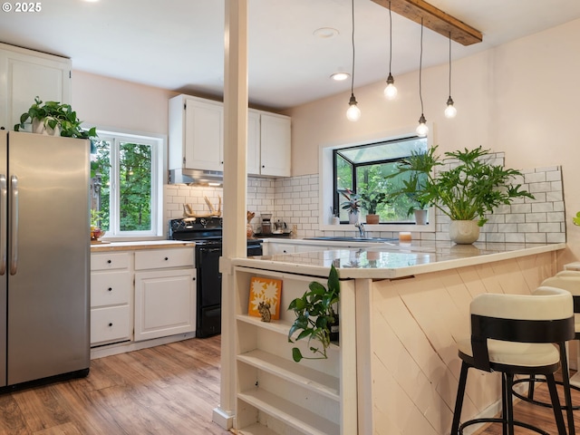 1171 Mabee Mines Rd, Washougal, WA 98671 - kitchen featuring freestanding refrigerator, black electric range, a peninsula, white cabinetry, and recessed lighting