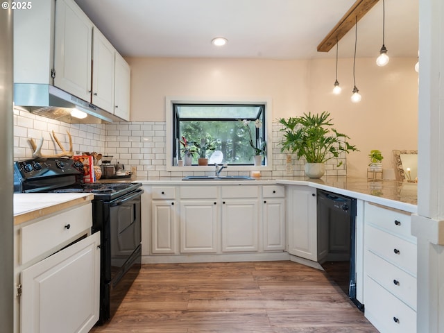 1171 Mabee Mines Rd, Washougal, WA 98671 - kitchen with black appliances, under cabinet range hood, light countertops, white cabinets, and tasteful backsplash