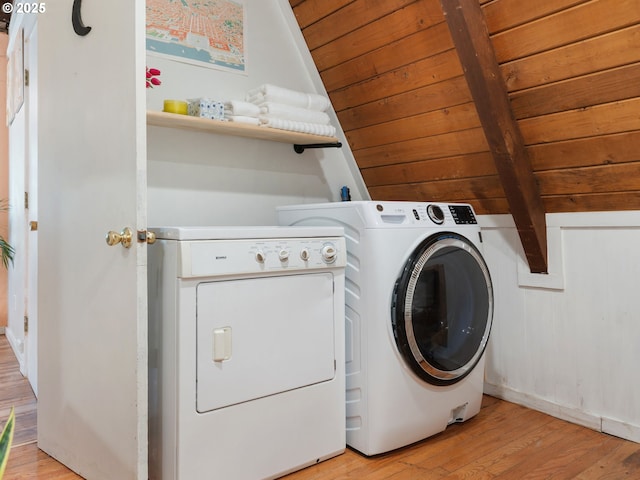 1171 Mabee Mines Rd, Washougal, WA 98671 - laundry room featuring washing machine and clothes dryer, wooden ceiling, and light wood-style flooring