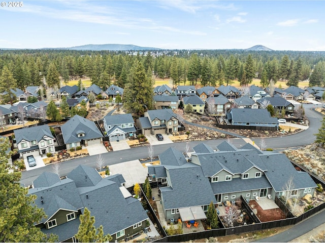 bird's eye view featuring a wooded view and a residential view