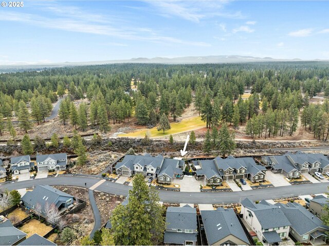 drone / aerial view featuring a forest view, a residential view, and a mountain view