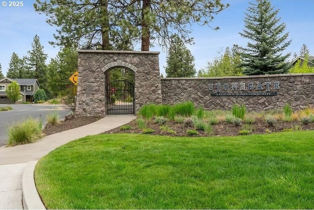 community sign with a yard and a gate