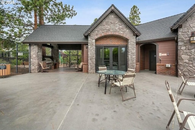 view of patio featuring french doors and fence