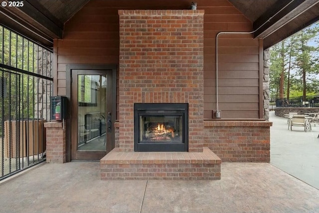 view of patio featuring an outdoor brick fireplace