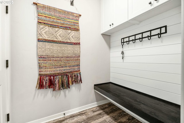 mudroom featuring dark wood-type flooring and baseboards