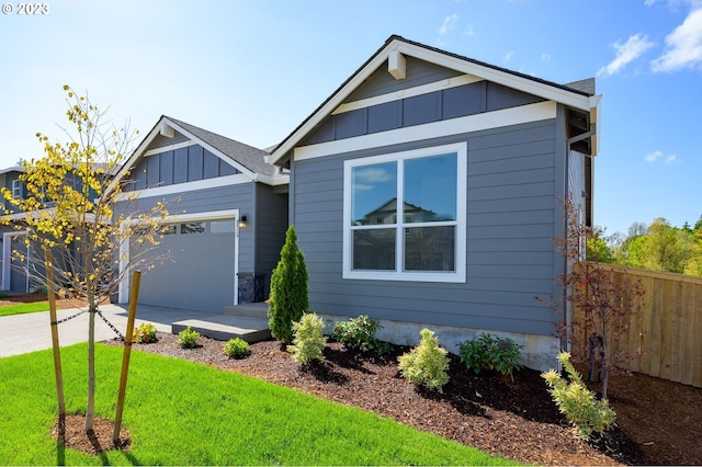 1790 S 32nd Ave Unit Lt710, Cornelius, OR 97113 - view of front of house featuring a garage, driveway, board and batten siding, fence, and a front yard