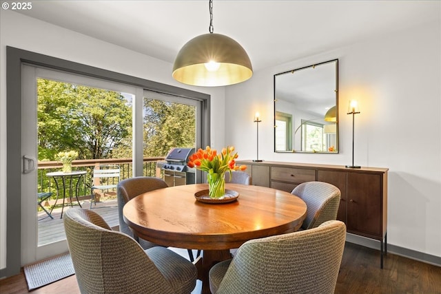dining space with wood finished floors and baseboards