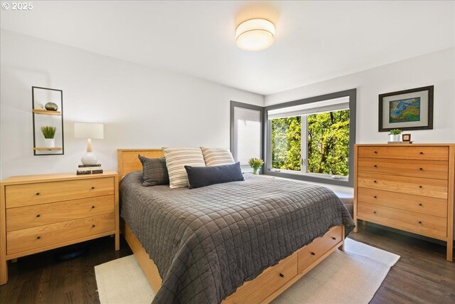 bedroom with dark wood-style flooring