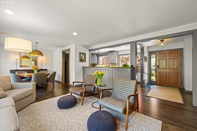 living room with dark wood finished floors, recessed lighting, and baseboards