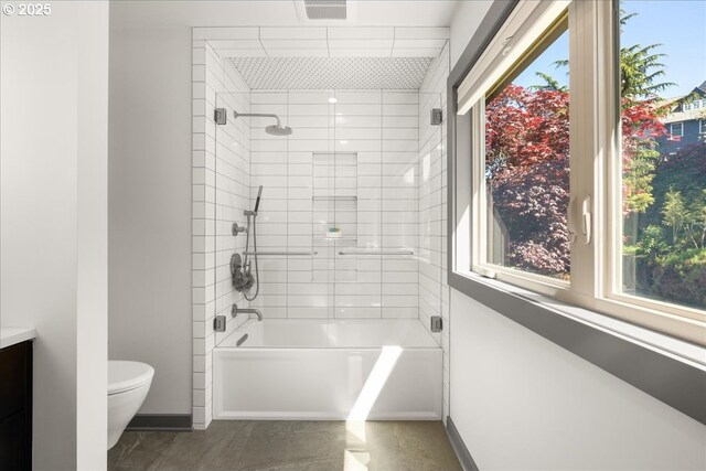 full bath with healthy amount of natural light, toilet, baseboards, and shower / bathtub combination