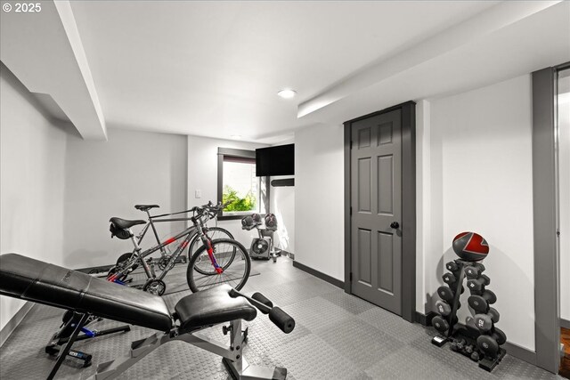 workout area featuring baseboards and recessed lighting