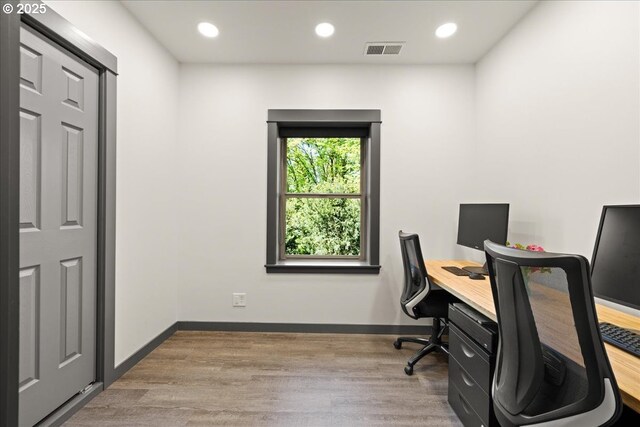 office featuring recessed lighting, wood finished floors, and baseboards