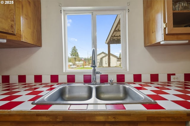 1305 E Van Buren Ave, Cottage Grove, OR 97424 - kitchen with a sink, tile patterned floors, brown cabinets, and tile countertops