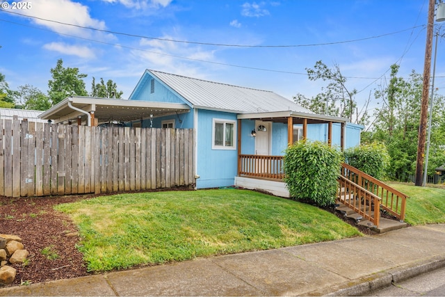 1305 E Van Buren Ave, Cottage Grove, OR 97424 - view of front of property with an attached carport, metal roof, and a porch
