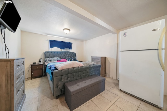 1305 E Van Buren Ave, Cottage Grove, OR 97424 - bedroom with freestanding refrigerator, light tile patterned floors, and a textured ceiling