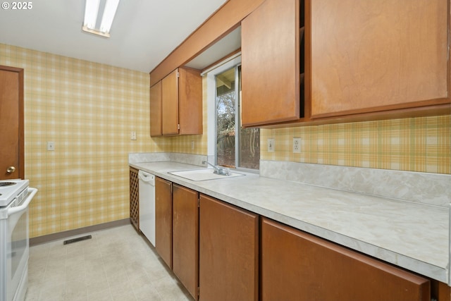 kitchen featuring sink and white appliances