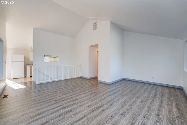 bonus room featuring high vaulted ceiling and light wood-type flooring