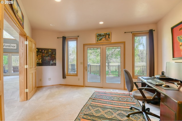 office with recessed lighting, light colored carpet, a healthy amount of sunlight, and french doors