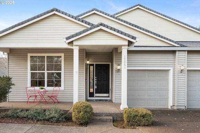 view of front of home with an attached garage and a tile roof