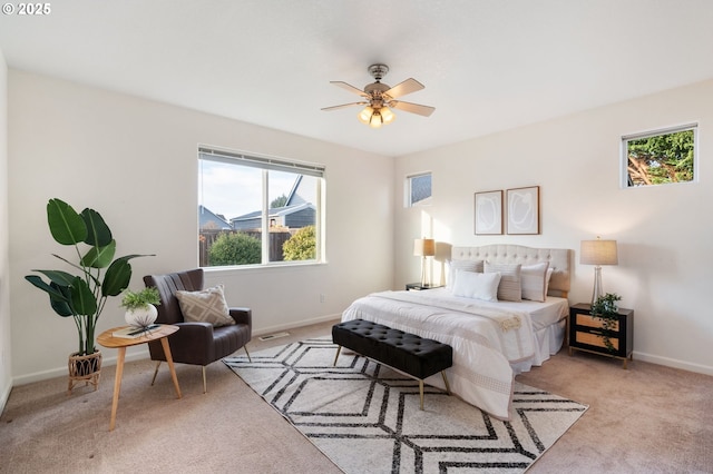 bedroom with visible vents, baseboards, ceiling fan, and light colored carpet