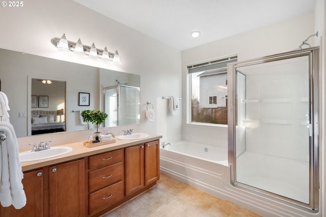 full bathroom with a garden tub, ensuite bath, a sink, and a shower stall