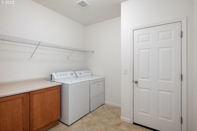 laundry area with baseboards, visible vents, and separate washer and dryer