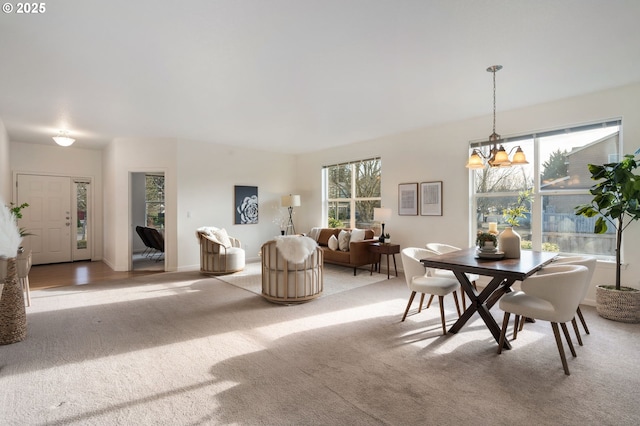 carpeted dining space featuring baseboards