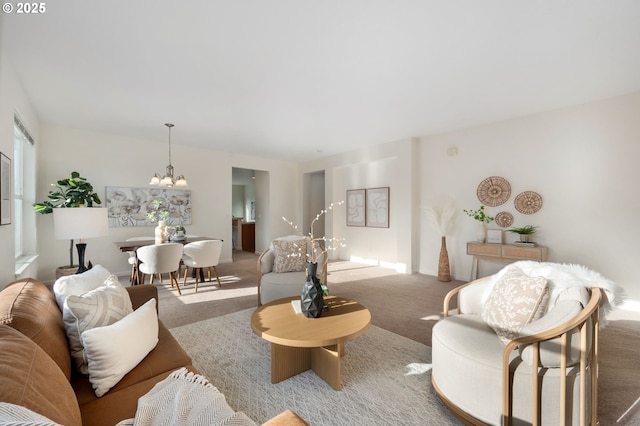 living area featuring carpet flooring and an inviting chandelier