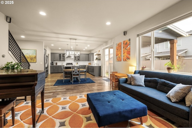 living room with light wood-style flooring and recessed lighting