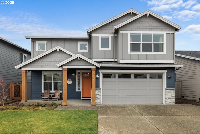 craftsman inspired home featuring a garage, a front lawn, and covered porch