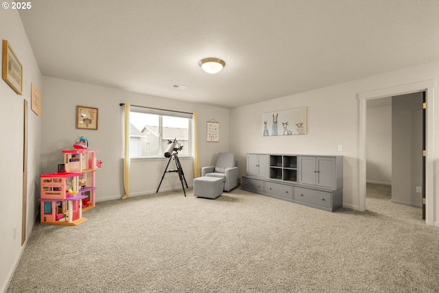 game room with carpet flooring, visible vents, and baseboards