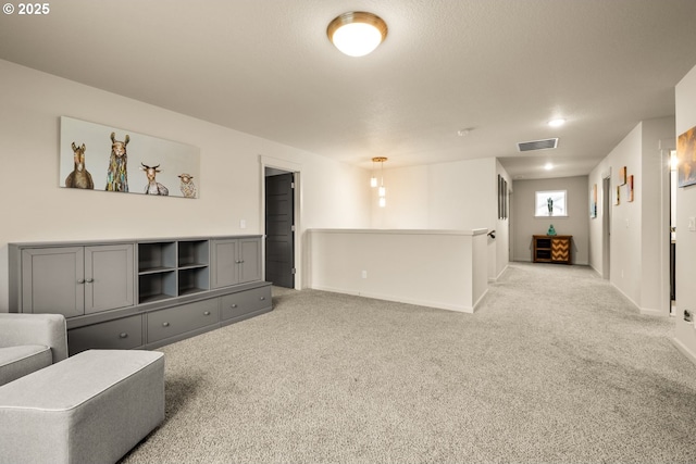 living room featuring carpet, visible vents, and baseboards