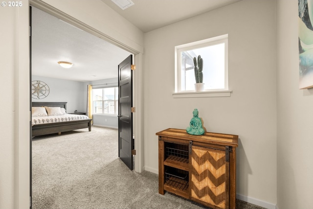 carpeted bedroom featuring visible vents and baseboards