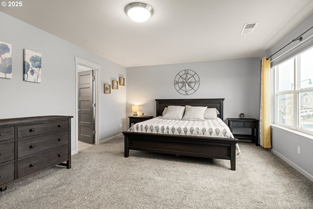 bedroom with light carpet, visible vents, and baseboards