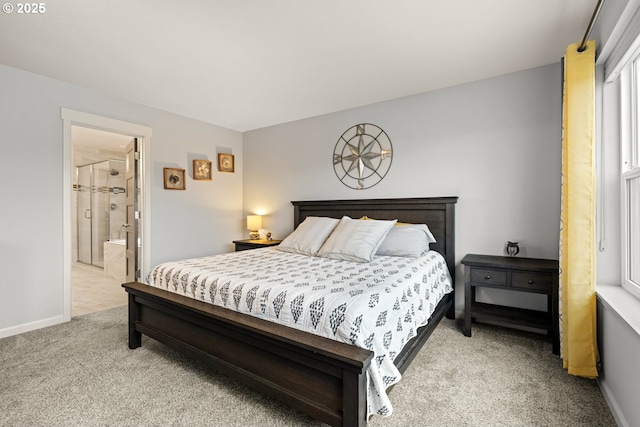 bedroom featuring ensuite bath, baseboards, and light colored carpet