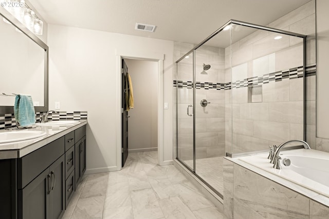 full bathroom featuring marble finish floor, a stall shower, a sink, and visible vents