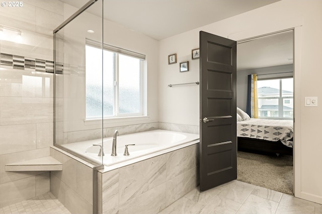 ensuite bathroom with a bath, ensuite bath, a wealth of natural light, and tiled shower