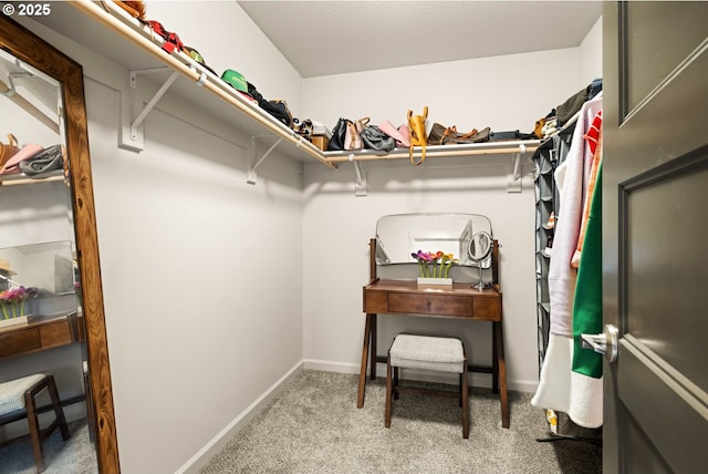 walk in closet featuring carpet flooring