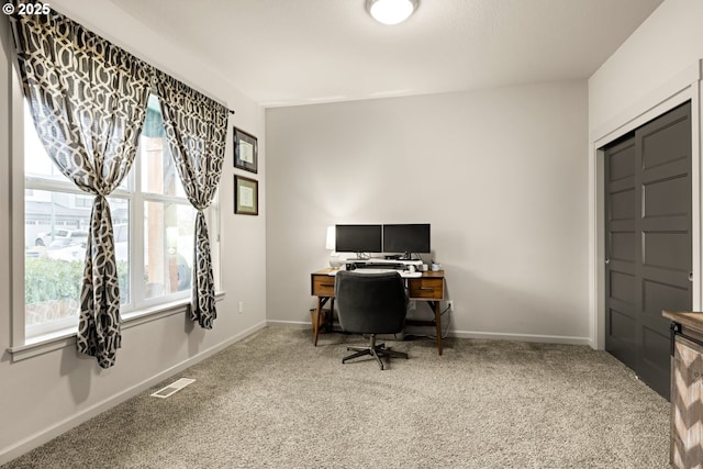 carpeted office featuring baseboards and visible vents