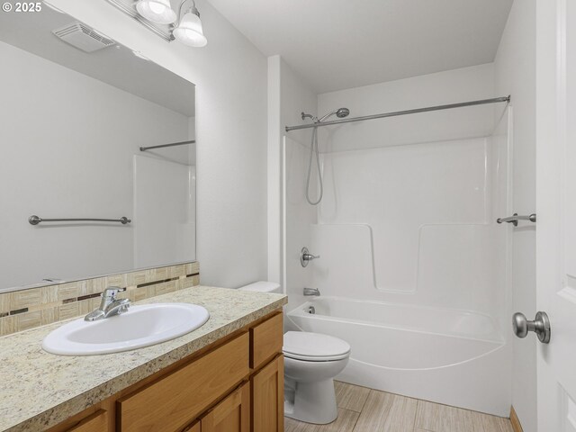 full bathroom featuring toilet, decorative backsplash, shower / bath combination, vanity, and wood finished floors
